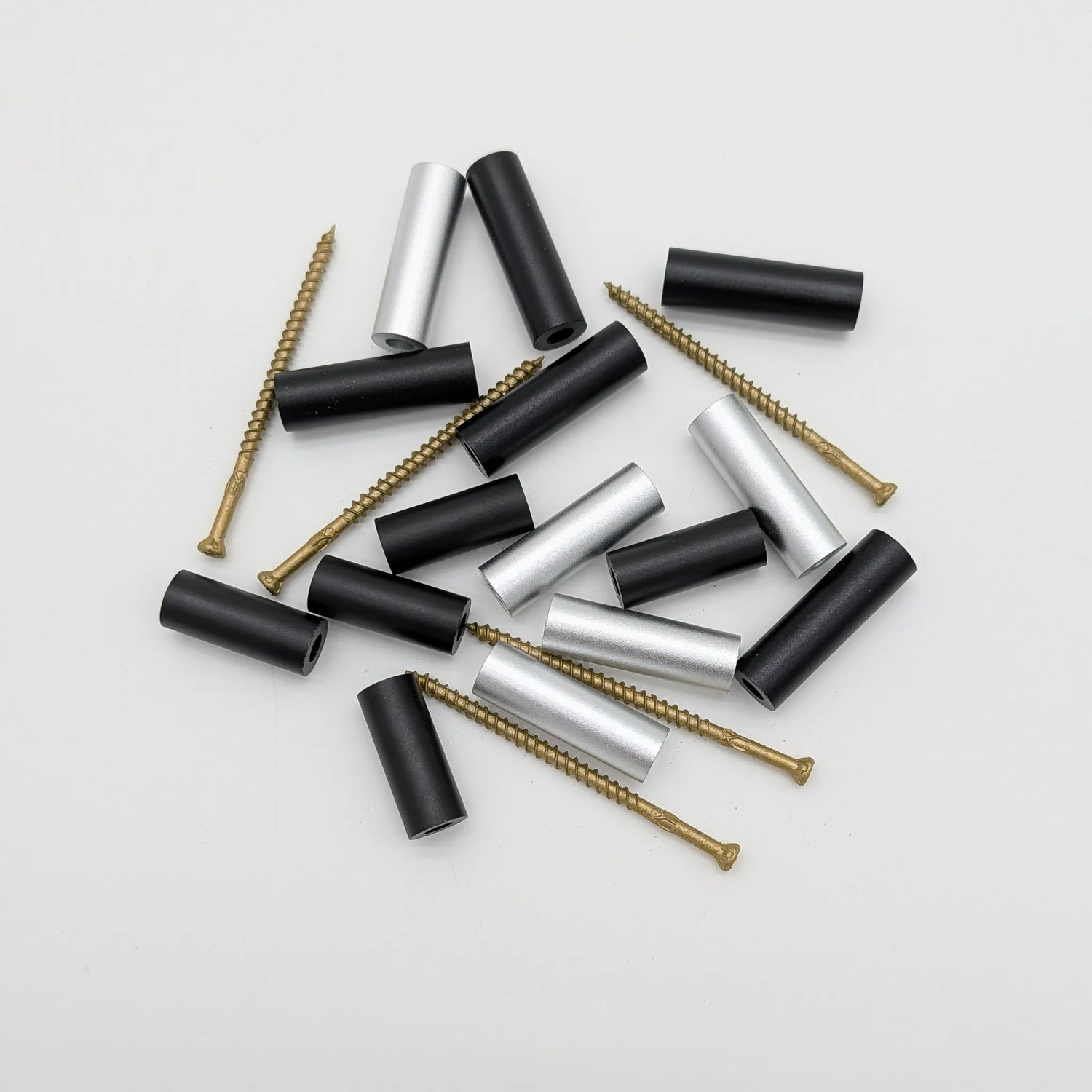 Three different sizes of spacers, in both black and silver, with the screws that are included in each set.