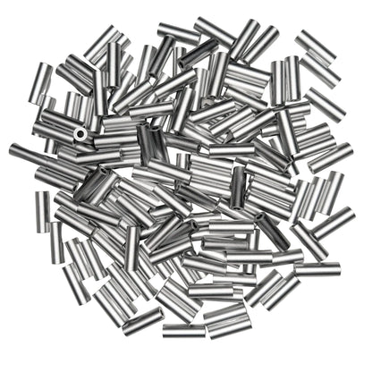 A pile of silver spacers scattered on a white background.