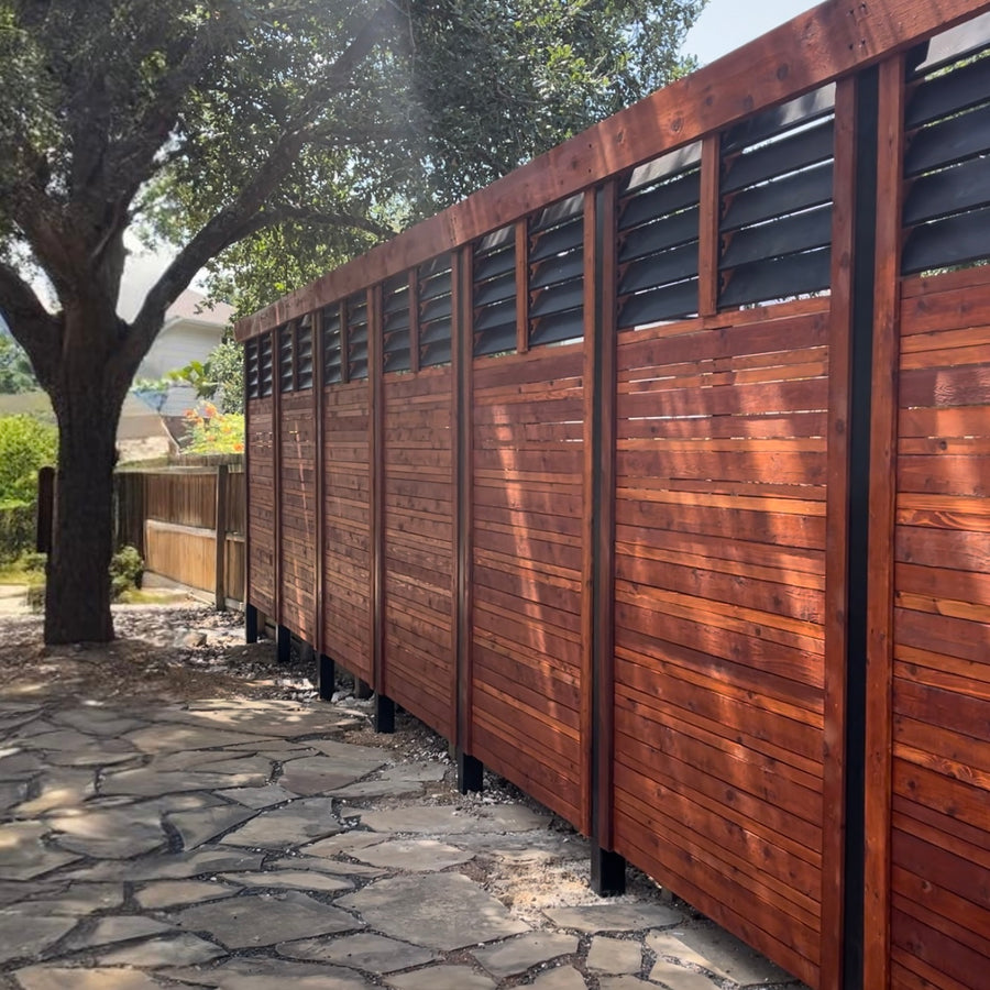 Stunning horizontal fence with black posts and a black louvered topper.