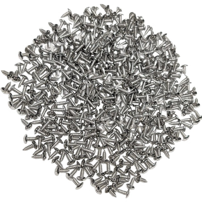 A pile of 500 3/4" silver stainless steel truss-head screws, scattered on a white background.