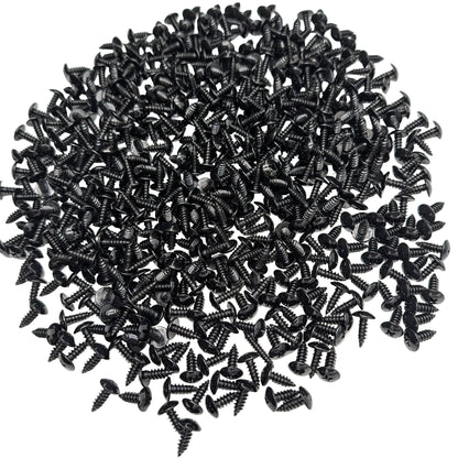 A pile of 500 5/8" black stainless steel truss-head screws, scattered on a white background.