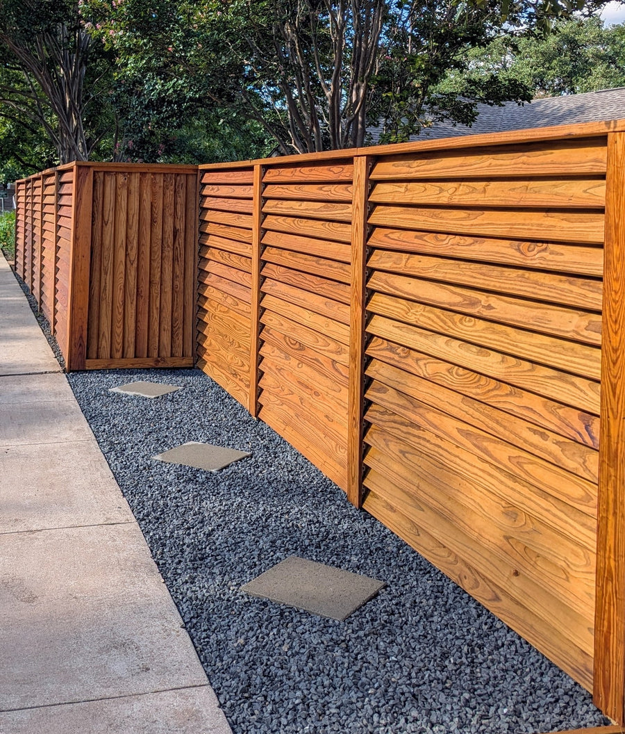 Modern louvered privacy fence design with wood slats and a clean, professional finish.