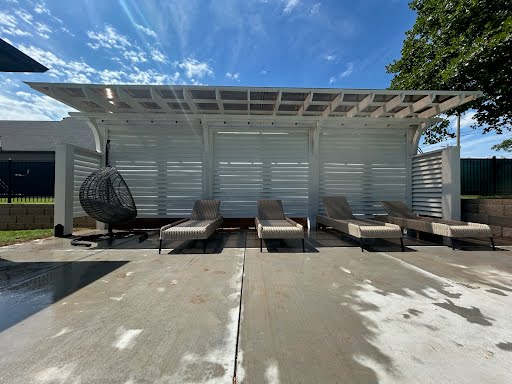 Cantilevered pergola with white 8' tall louvered privacy wall