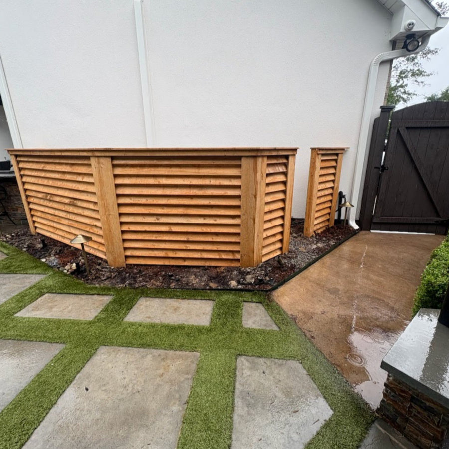 Five foot tall, wood horizontal louvered panels surrounding equipment on the side of a house