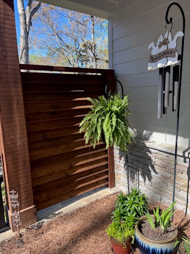 Louvered Wood Horizontal Privacy Screen between a house and column
